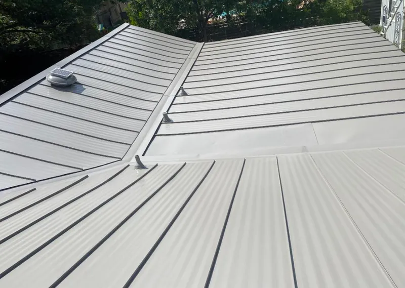 Solar attic fan installed on a metal roof for Roof Ventilation in South Holland