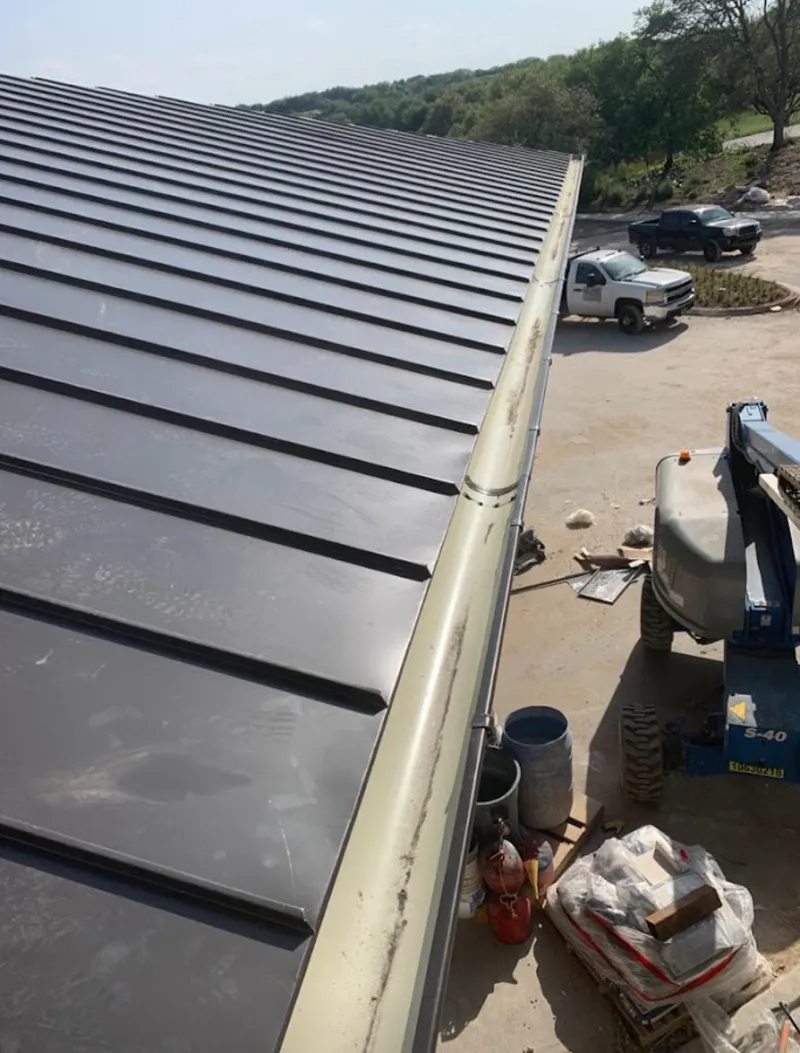 Standing seam panel and gutter detail on a metal roofing jobsite in South Holland